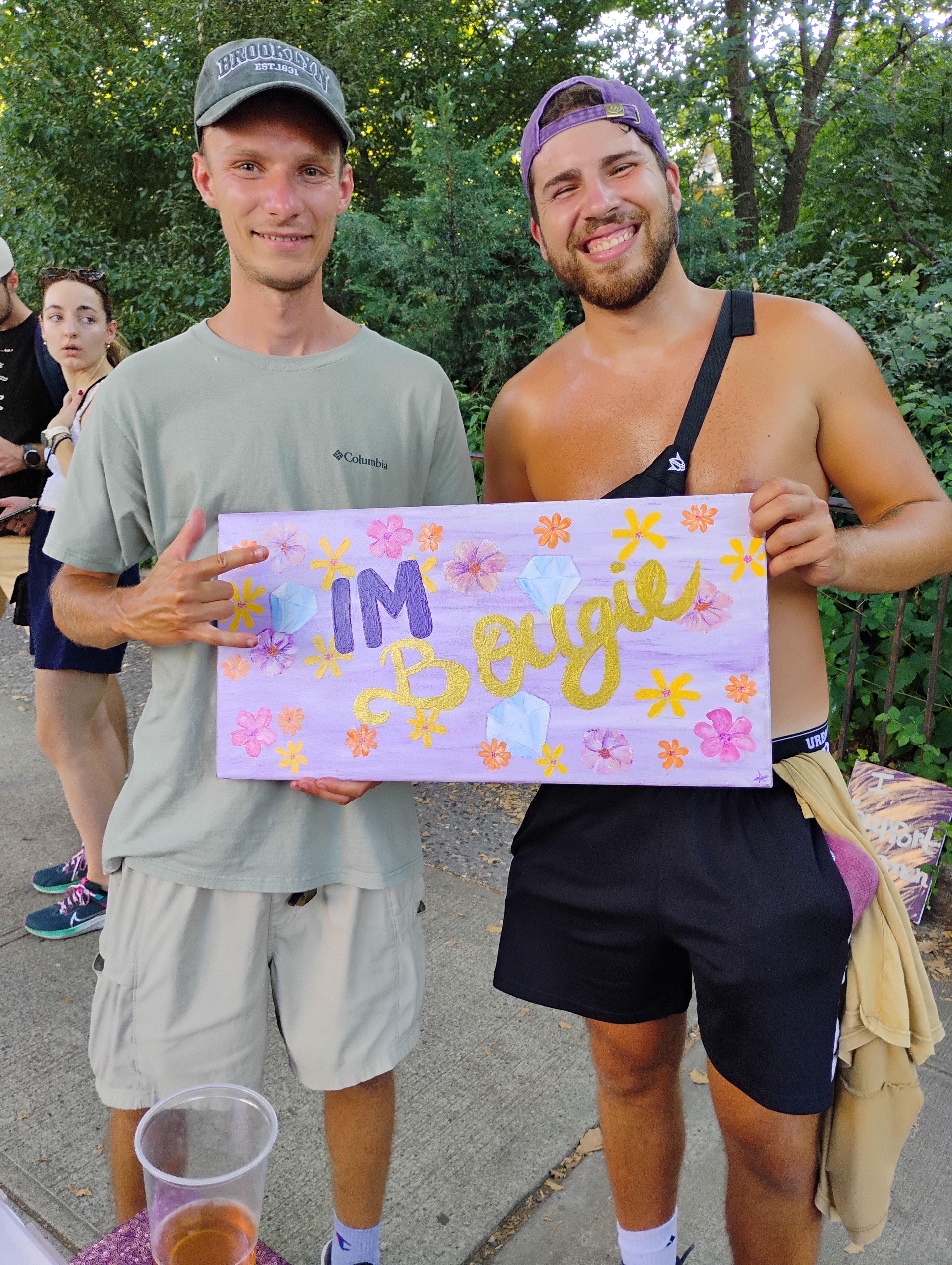 Friends with Bougie 420 sign at a summer gathering