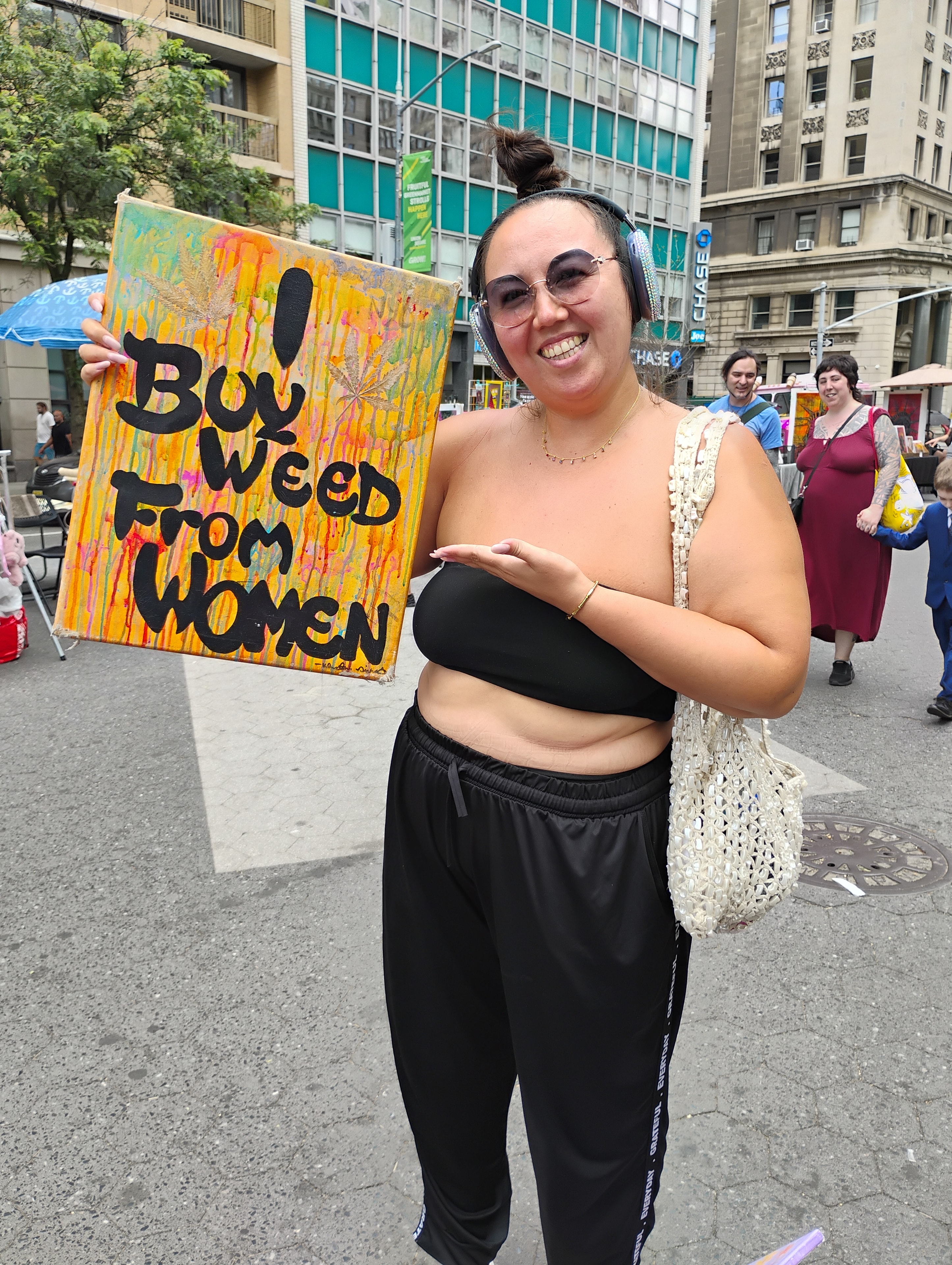 Community member with Buy Weed From Women sign in NYC